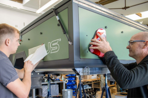 An image showing a close-up of two men building the opus self inflating trailer tent